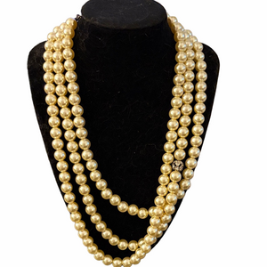 Vintage 1950s three strand faux pearl necklace with rhinestone embellishment.